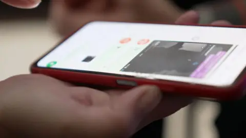 A smartphone displays a text conversation with the exchange of images and voice notes. 