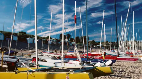 Getty Images Dozens of boats on Abersoch beach on a sunny day.