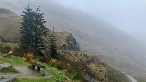 A mountain road on a wet and windy day