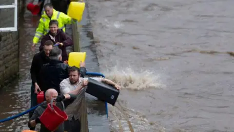 Pontypridd residents bail out their houses after flooding