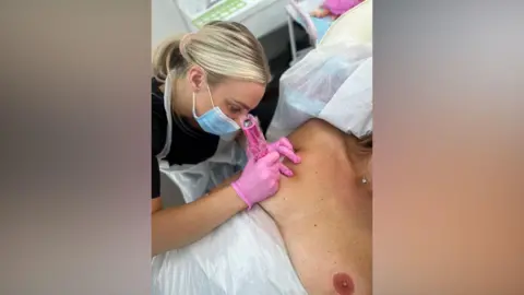 Emma Roberts Emma Roberts tattooing nipples onto a woman's breast following a masectomy