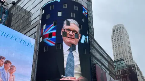 BBC The Prime Minister's image is being projected onto the NASDAQ screen in Times Square, New York, ahead of his visit 