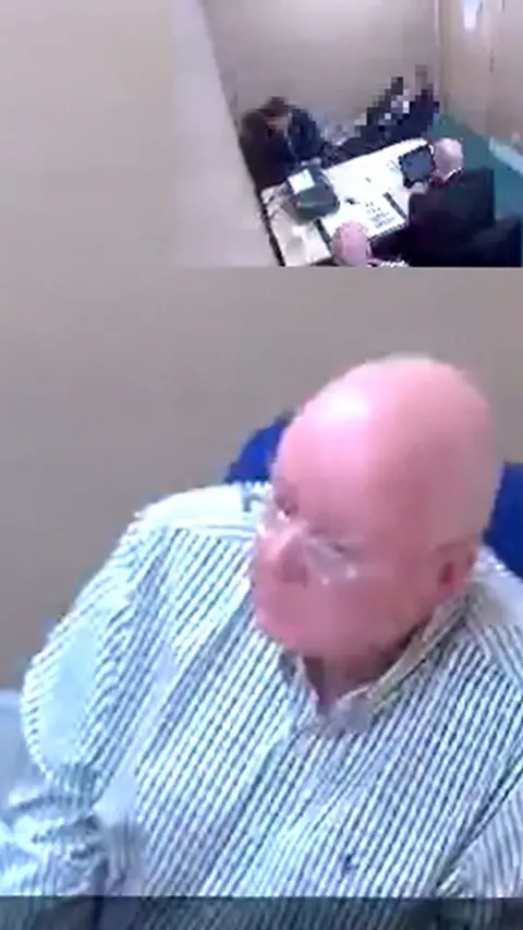 Bald man with glasses