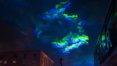 Mark McNulty strands of green and blue lights above the museum warehouses on the Albert Dock