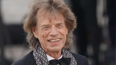 Mick Jagger wearing black tie for a formal event.