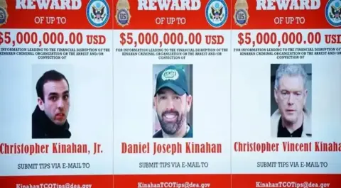 PA Media Three wanted posters of Christopher Kinahan Junior, Daniel Joseph Kinahan and Christopher Vincent Kinahan. Photos of the men are place in the middle of a 'Reward of up to five million USD' along with a tip off email address that reads KinahanTCOTips@dea.gov