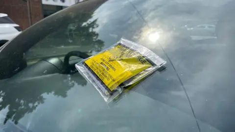 BBC Parking tickets stuck onto a car window
