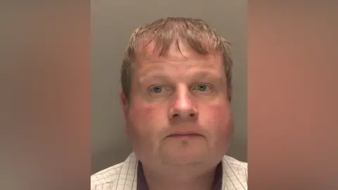 Police mugshot of Marc Gothorp. He has fair hair and is wearing a light-coloured shirt. He is looking directly at the camera.