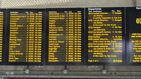 A timetable showing cancelled trains at Guildford Station on Wednesday