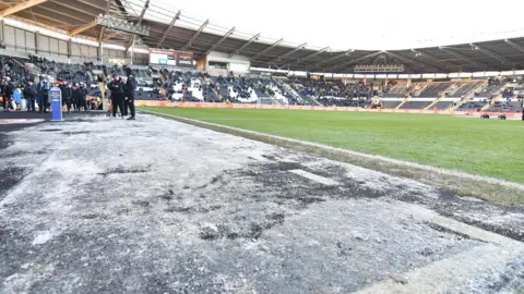 Frozen sections of turf surrounding the pitch at Hull's MKM Stadium