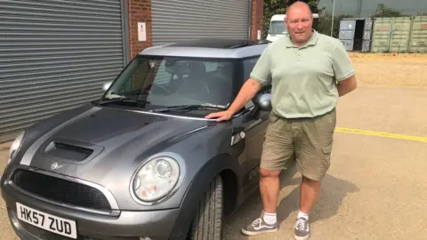 John Devine/BBC March mayor Gary Christy with the Mini Cooper he raffled to raise funds for local charities