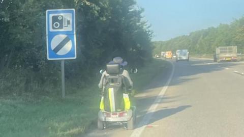 A man on a disability scooter on the A11 in Norfolk