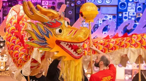 Blackstock Market A gold, orange and red Chinese dragon used in a performance to celebrate Chinese New Year at Blackstock Market in Liverpool.