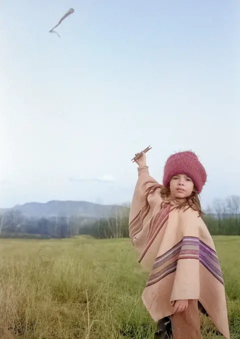 Paul Griffin A girl flies a kite in a colourised image