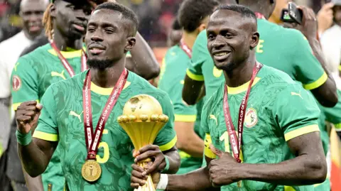 Senegal players celebrate with the Africa Cup of Nations title