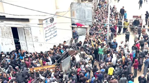 A crowd at a bakery in Deir Al Balah