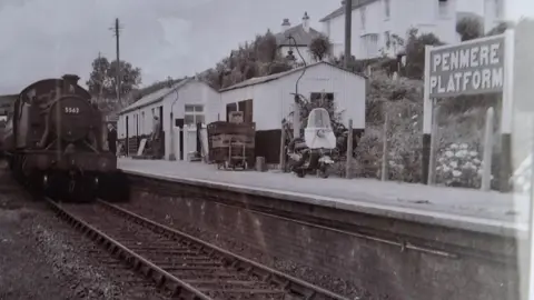 Steve Lloyd A black and white picture from the 1950s. A steam train pulls into Penmere station 