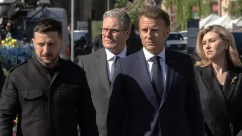 Sir Keir Starmer and Emmanuel Macron appear beside Volodymyr Zelensky in Kyiv