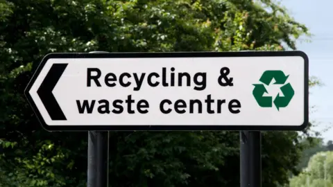 Planet One Images/Universal Images Group via Getty Images Sign that reads 'recycling and waste centre'