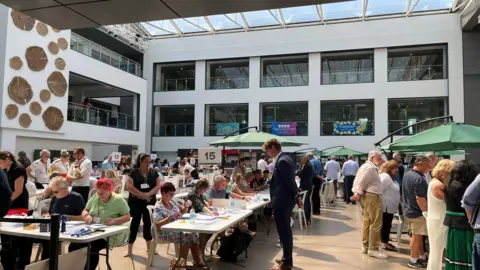 Votes being counted in a busy hall in Trowbridge