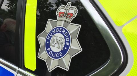 Humberside Police logo on the side of a patrol car