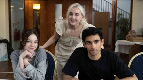 BBC/Moonage/Sally Mais From left to right Emma Myers, Holly Jackson and Zain Iqbal gathered for a script read through of the TV series