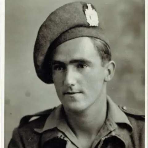 An old black and white photo taken of a young Douglas Baldwin in his army uniform. 