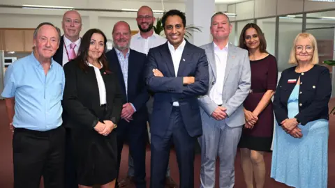 Pictured are eight either current or former members of Reform UK cabinet at Worcestershire County Council, with the party's head of policy Zia Yusuf.