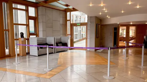 An area of a Scottish Parliament lobby cordoned off by purple tape
