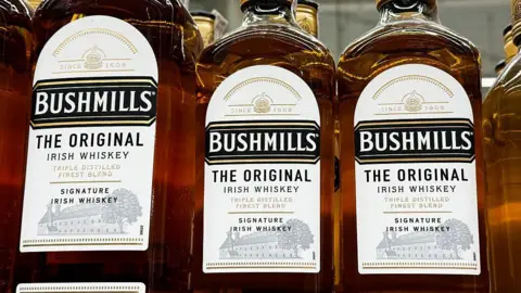 Getty Images Bottles of Bushmills whiskey sitting in a row. 