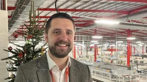 Jay Brooks stands on a balcony overlooking the main Medway Mail Centre floor at Rochester with a Christmas tree in the background