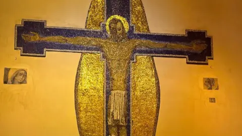 Oldham Mural & Cultural Heritage Trust The same mural but everything around Jesus on the cross is painted white expect for the faces of Mary and St John.