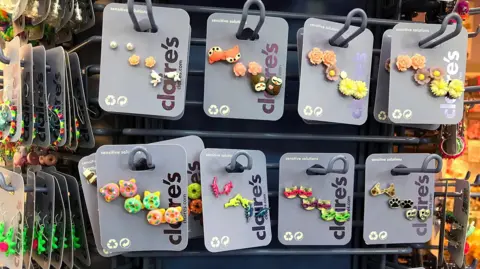 Getty Images Lots of Claire's earring studs on a rack
