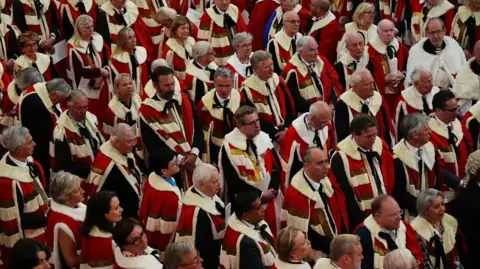 Members of the House of Lords listen to the King's Speech during the State Opening of Parliament in chamber of the House of Lords at the Palace of Westminster, London in 2024.