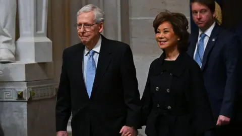 Mitch McConnell and his wife, former transportation secretary Elaine Chao, attend Donald Trump's second inauguration in January.