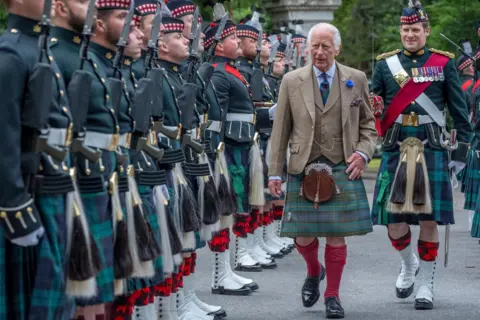 Jane Barlow / PA Media King Charles III inspects the Balaklava Company at Balmoral