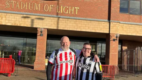 Sunderland fan Chris Johnson and Newcastle fan Ricky Hoult outside the Stadium of Light