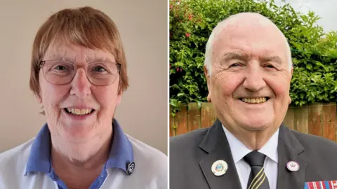 A composite image of Margaret Lester and Tom Fennelly. On the left, Lester is smiling while looking directly into the camera. She has short brown hair and is wearing a blue and white girl guiding uniform, with a blue pin on her collar. Fennelly, on the right, is also smiling at the camera. He has short white hair and is wearing a black suit with various medals and badges pinned to it.