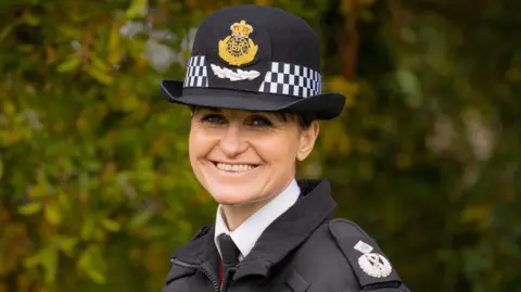 Hampshire & Isle of Wight Constabulary Sam de Reya stands in police uniform, smiling at the camera.