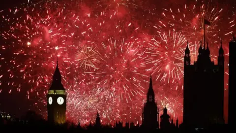 EPA Red fireworks light up the sky over London with the Big Ben visible on the left. 