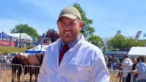 John Ker leading a calf in a show ring at a county Show