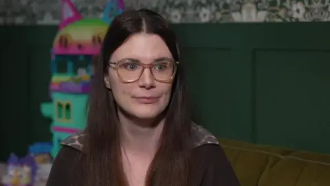 A shot of Zenobia while being interviewed for television in her home.