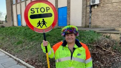 BBC Lollipop lady holding lollipop sign