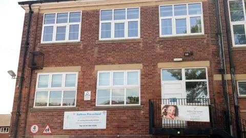 The photo shows a wider perspective of the brick building owned by Leicester City on Linwood Lane.