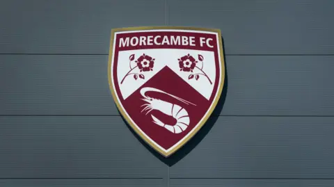 Morecambe's crest on their Mazuma Stadium home