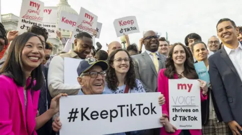 People hold signs on Capitol Hill in support of TikTok