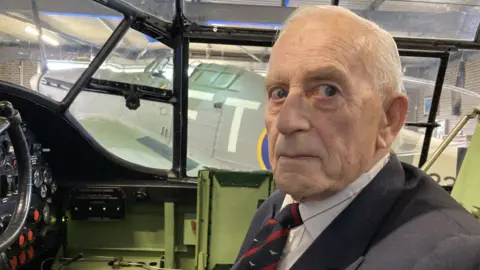 Roger Dixon sitting in a Lancaster simulator at the RAF Museum in Manston