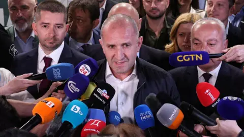 Rumen Radev, former Bulgarian president and leader of Progressive Bulgaria coalition, speaks to the media after the first exit polls at the parliamentary election.