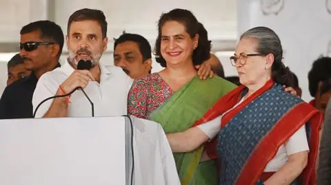 Getty ImagesFormer Congress President Sonia Gandhi on right with Priyanka Gandhi Vadra in center and Rahul Gandhi on left at a public meeting on May 17, 2024 in Rae Bareli