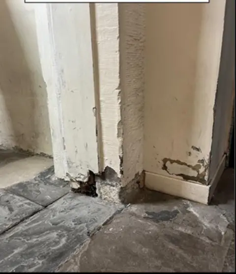 HMIPS The entrance to a cell, with chipped and broken stonework near the ground